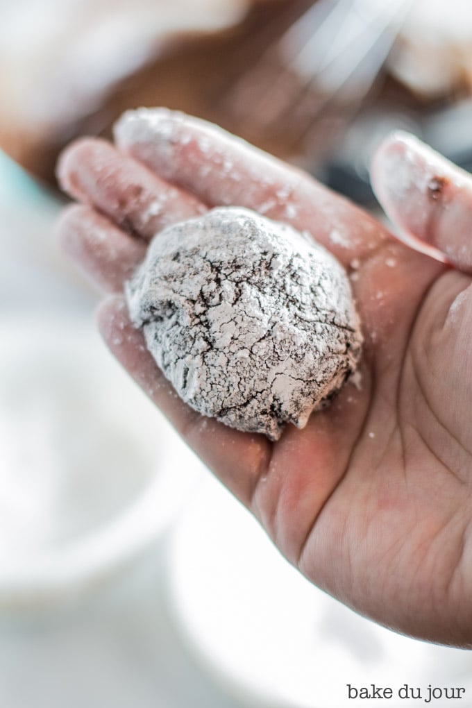 Dough for one chocolate crinkle cookie after it's been rolled in sugar