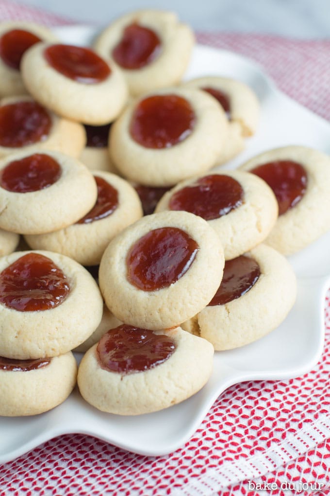 A pile of Strawberry Jam Thumbprint Cookies on a white dish