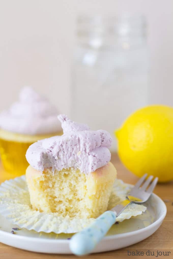 A Lemon Lavender Cupcake with a bite taken out of it