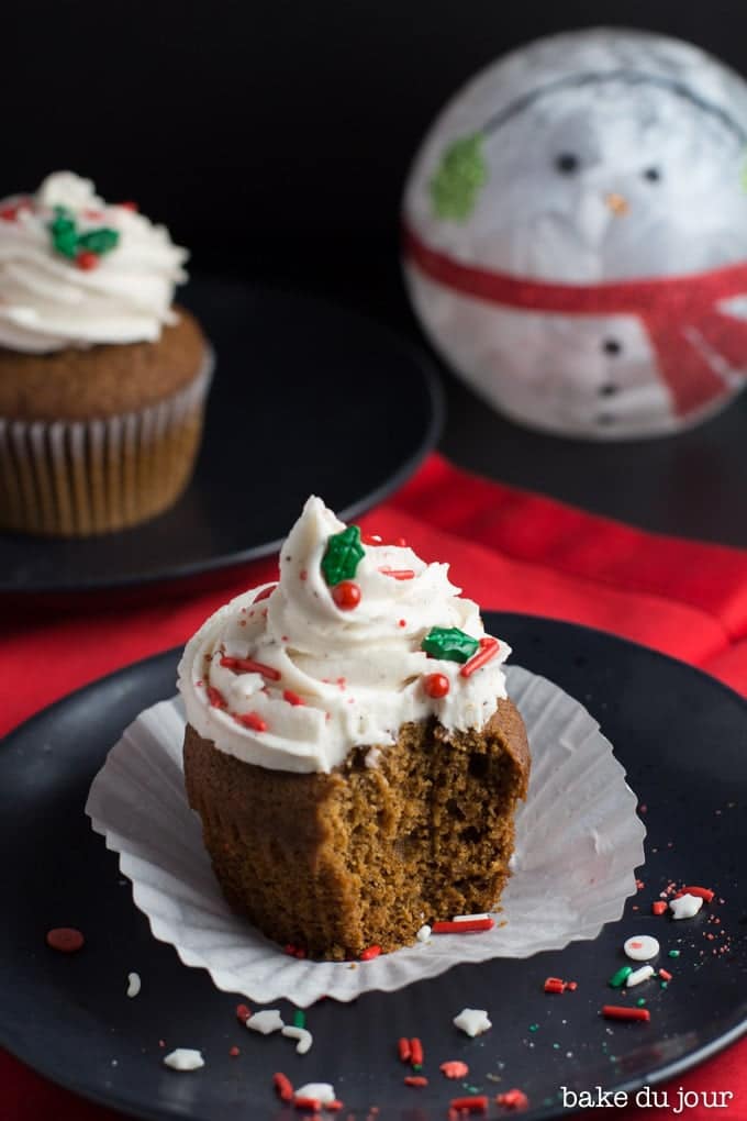 A Gingerbread Eggnog Cupcake with a bite taken out of it