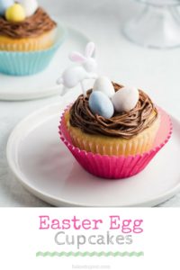Pinterest graphic - two yellow cake cupcakes topped with chocolate buttercream frosting, three Cadbury mini eggs, and an Easter bunny party pick