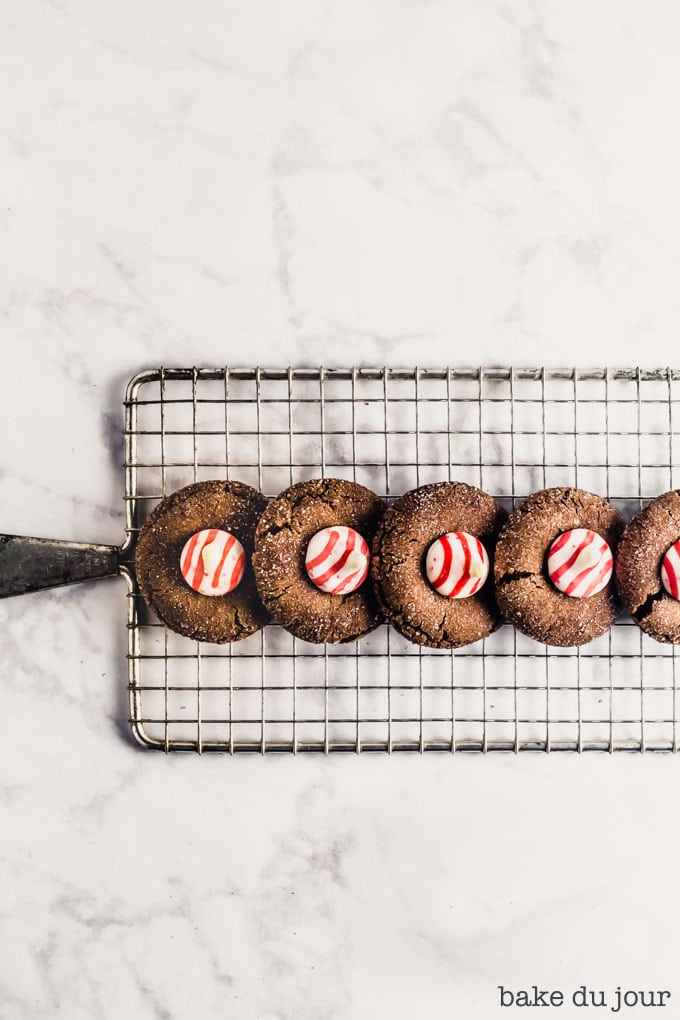 A set of five Chocolate Peppermint Blossom Cookies on cooling rack